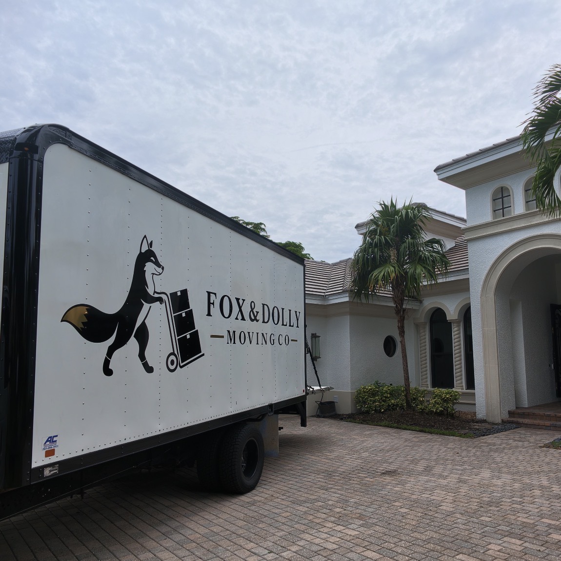 Fox and Dolly moving truck at a luxury Naples home