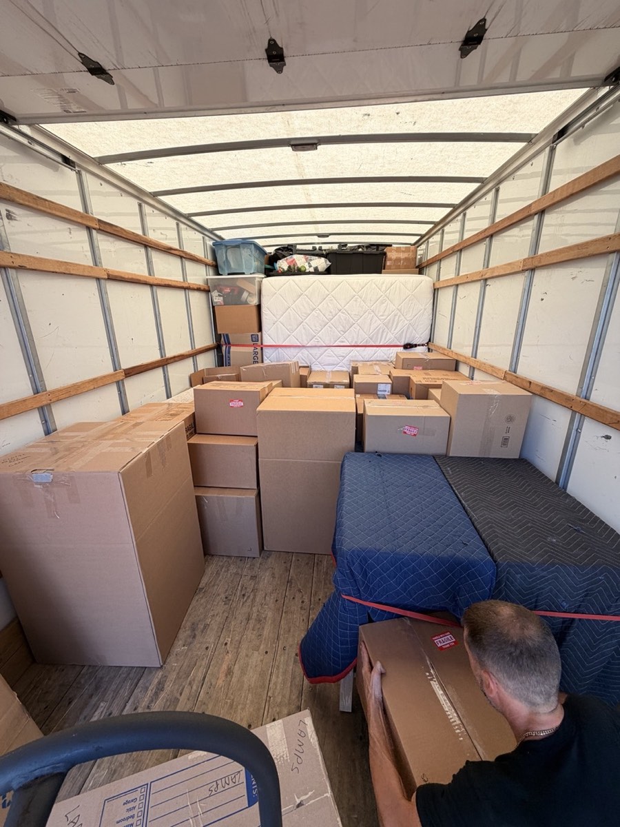 Protected furniture and labeled boxes organized inside the Fox and Dolly moving truck